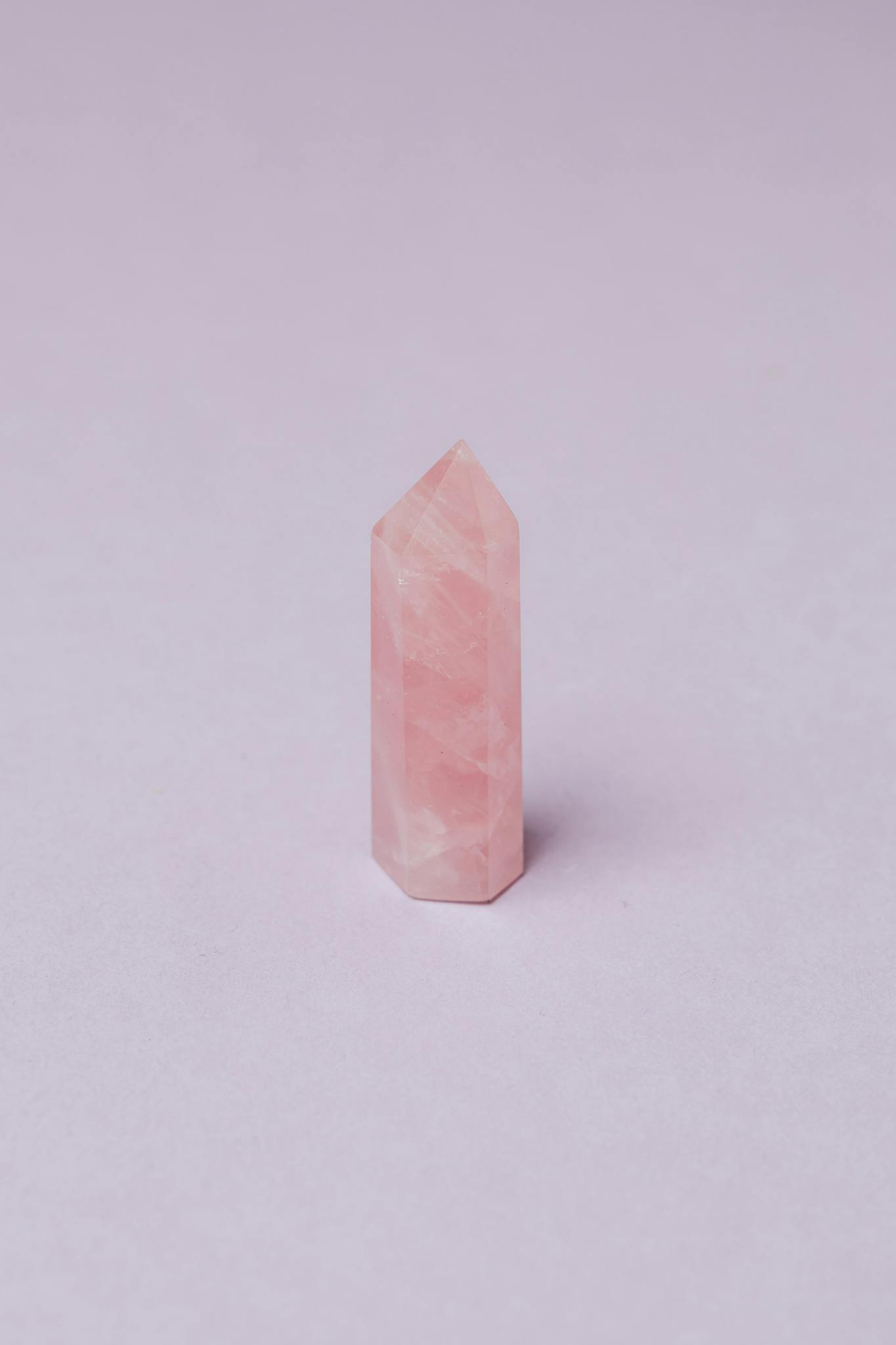 Closeup of pink quartz natural stone obelisk polished in jewelry workshop